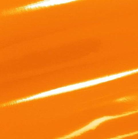 a close up of a shiny orange surface